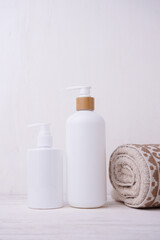 Cosmetic bottle mockup, on a beige background, hand holding the bottle, mockup for branding your product