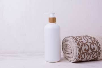 Cosmetic bottle mockup, on a beige background, hand holding the bottle, mockup for branding your product