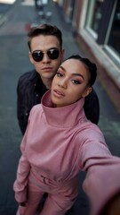 A young black woman with a modern look taking a selfie with her boyfriend