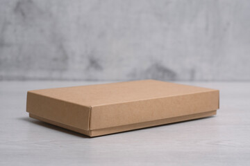 Eco friendly packaging sustainable shipping box on light background. Simple and sturdy packaging for product protection.