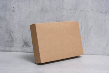 Eco friendly packaging sustainable shipping box on light background. Simple and sturdy packaging for product protection.