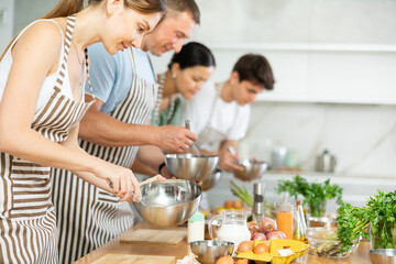 Chef apprentices learn how to properly beat eggs with a whisk in a cooking class