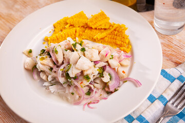 Ceviche pickled trout in lime juice with boiled corn