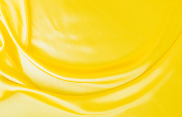 yellow gold satin texture that is white silver fabric luxurious shiny that is abstract silk cloth background with patterns soft waves blur beautiful.