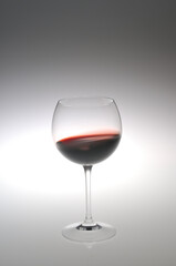 Red wine swaying in a glass / 赤ワインがグラスの中で揺れている