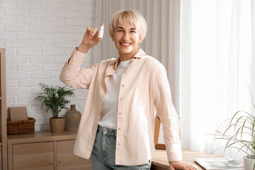 Mature woman with eye drops at home