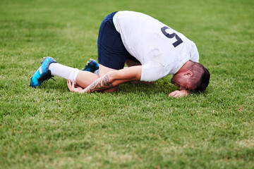 Man, sport and knee injury with grass field for emergency, medical attention or accident in nature. Male person, athlete or rugby player with pain, joint inflammation or leg sprain at outdoor game