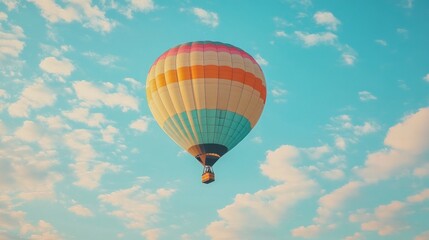 Fototapeta premium Colorful Hot Air Balloon Soaring Through a Blue Sky