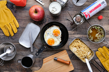 Fried eggs on a wooden table at the camp.