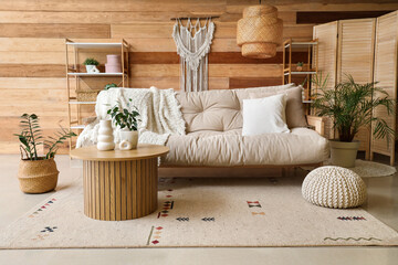 Interior of cozy living room with beige sofa, table and shelf units