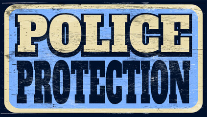 Aged and worn police protection sign on wood