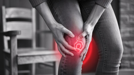 close up photo of a person holding a sore knee