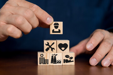 Health safety environment HSE education industry Concept, Man hand holding wooden cube block.