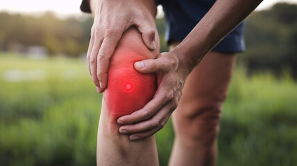 close up photo of a person holding a sore knee