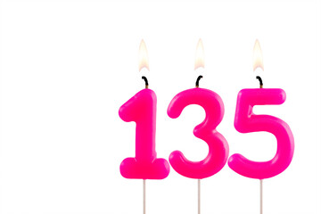Pink number 135 birthday candle lit on white background
