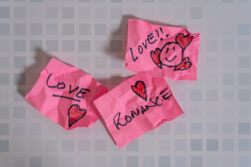 Crumpled love notes showing the concept of the end of a love relationship
