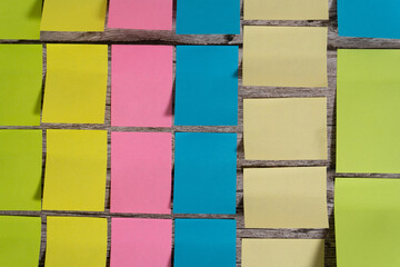 Post-it notes and sticky notes sorted by color and size on a table