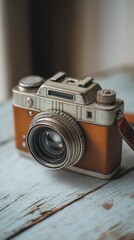 Vintage camera with a leather casing resting on a wooden surface.