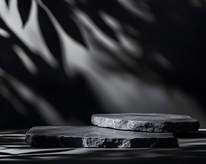 Obraz premium Two dark stone slabs with soft shadows creating an artistic, minimalist composition.