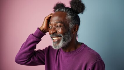 Joyful Man With Unique Hairstyle Shares a Moment of Laughter Against a Colorful Backdrop