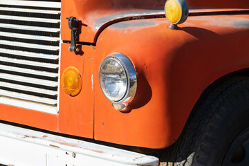 Headlight and turn signals on an old orange car