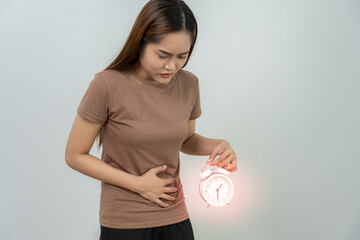 Asian women have stomach ache. Stomach ache due to eating irregularly, menstrual cramps,...