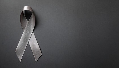 Brain Cancer Awareness Symbol. Gray Ribbon with Copy Space for Text. Dark Gray Background Isolated. Flat Lay Top View.