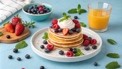 Delicious Pancakes Stacked with Fresh Berries and Whipped Cream