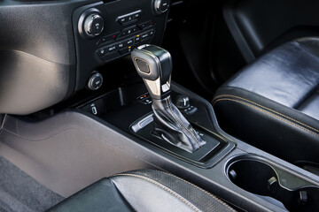 automatic transmission shift selector in the car interior. Closeup a manual shift of modern car gear shifter. 4x4 gear shift