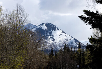 Light snow on a mountain in Anchorage, Alaska on a cloudy spring day.