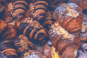 Fresh baked goods, chocolate and cream croissants on a supermarket display