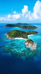 Fototapeta premium This breathtaking tropical island showcases vibrant turquoise waters surrounding lush greenery, inviting travelers to explore its serene beauty beneath a clear blue sky