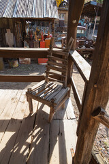 Dilapidated wooden chair on a front porch