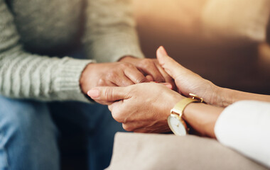 Psychologist, woman and holding hands for support, counseling and empathy for trauma in office....