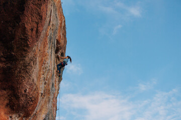 rock climber girl. rock climber girl climbs an overhanging rock.