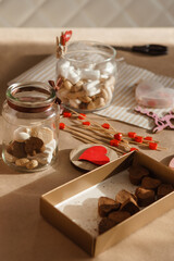 Children's hands collect a sweet gift for Valentine's Day. A gift for the holiday, a video blog entry. Demonstrating the colors of 2025 - Mocha Mousse