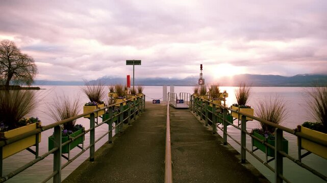 Timelapse of Rolle wharf at sunrise with Lake Geneva in Canton of Vaud Switzerland
