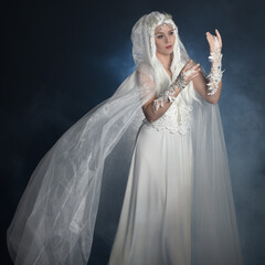 close up portrait of beautiful blonde female model wearing  white fantasy snow fairy gown,  magical...
