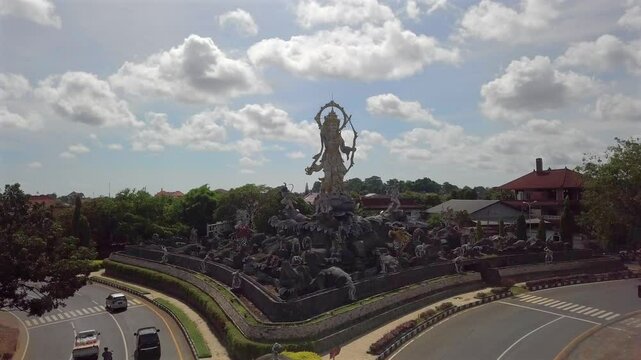 Titi Banda,Spectacular street statue in Denpasar,Bali.Lord Rama and his Monkey troops around him.Road Junction.Sunny day with clouds