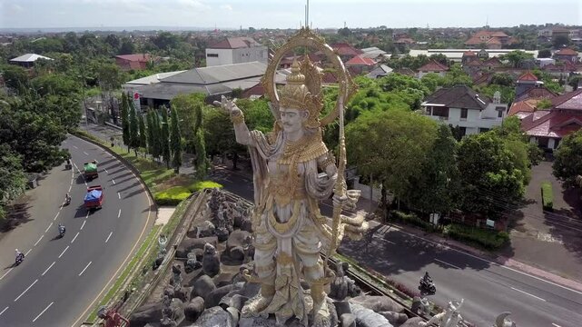 Titi Banda,Statue at road Junction in Denpasar,Bali.Aerial,Half Circle Pan around the Spectacular Statue.Sunny