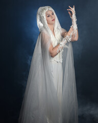 close up portrait of beautiful blonde female model wearing  white fantasy snow fairy gown,  magical...