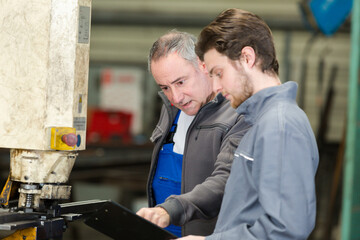 young manual worker with teacher