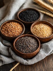 Four Bowls of Various Grains and Seeds on Rustic Wooden Table.