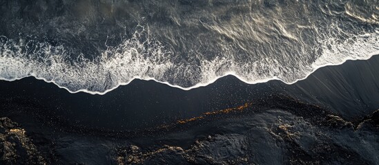 Aerial View of Waves Gently Hitting Black Sand at Punaluu Beach in Hawaii