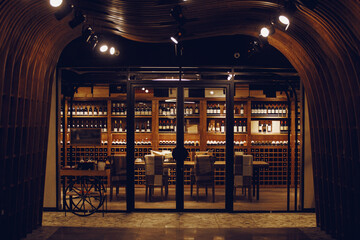 Wine room in shop cellar. Bottles of various wines lie beautifully on the counter. 