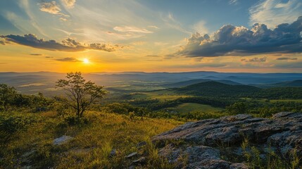 Fototapeta premium Serene panoramic sunset landscape with rolling hills and dramatic clouds in the background under a colorful sky.
