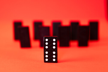 group of domino tiles with a winning leader at the front - dare to be different concept photo