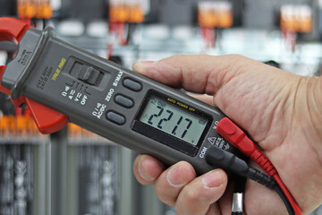 Measurement of electrical parameters in a switchboard using a multimeter. Soft focus. 