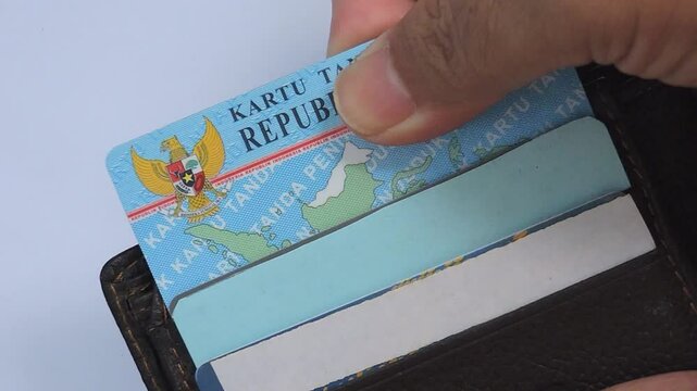 Close-up view of an attractive Indonesian Identity Card (KTP) in a dark leather wallet. Perfect for identification themes, everyday life