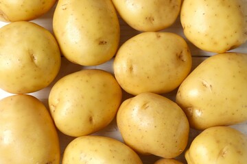 Young potatoes. Fresh potatoes on a wooden background. Harvesting collection. organic, freshly dug potatoes. Agricultural background. Vegan. Vegetables.Place for text.Copy space